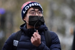 FILE - Simon Cheng, founder of Hongkongers in Britain, attends an event protesting shrinking political freedoms in Hong Kong, in Leicester Square, central London, Dec. 12, 2020.