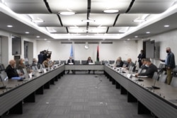 Representatives of rival factions in the Libya conflict are seen during talks at United Nations offices in Geneva, Switzerland, Oct. 20, 2020.
