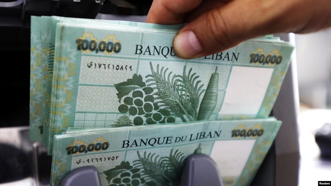 FILE - Lebanese pound banknotes are seen at a currency exchange shop in Beirut, Lebanon, June 15, 2020. 