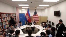 U.S. Ambassador to Cambodia William Heidt, rear center, gives a press conference at the U.S. Embassy in Phnom Penh, Cambodia, Tuesday, Sept. 12, 2017. Heidt has delivered a sharp response to allegations by Prime Minister Hun Sen that Washington is seeking to dislodge his government, denying the allegations and warning that Cambodia is doing itself damage international with its anti-American campaign. (AP Photo/Heng Sinith)