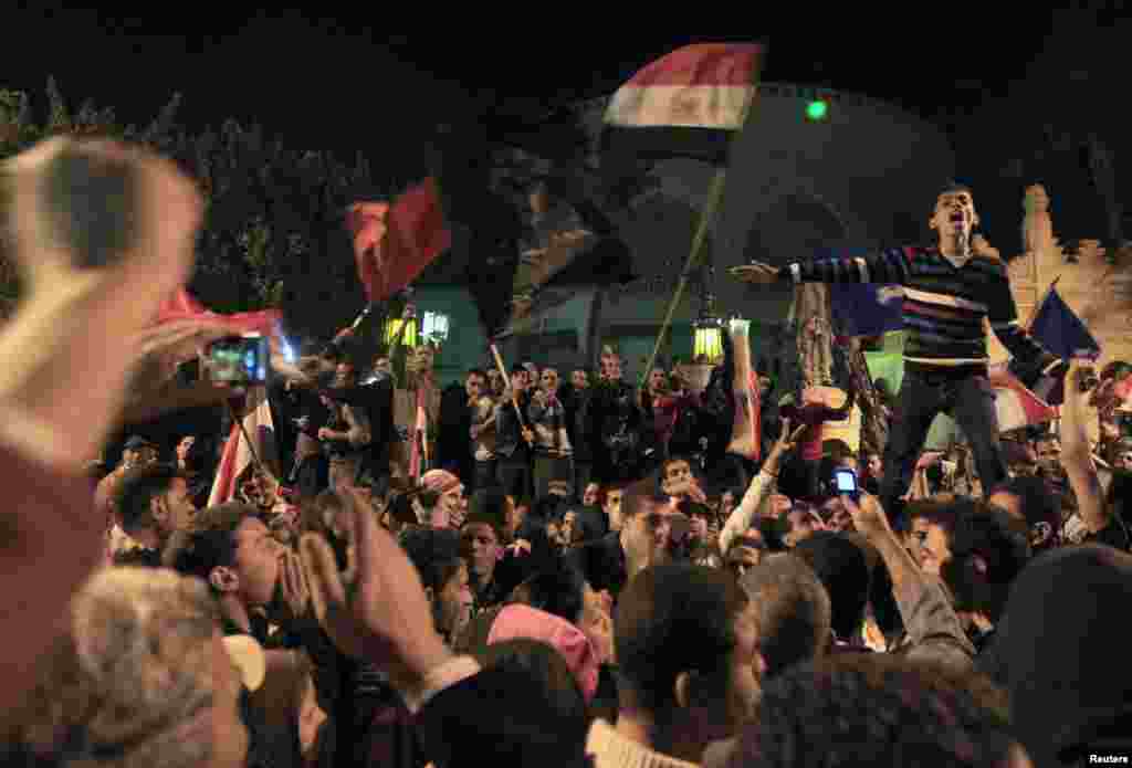 Protesters against Egypt's President Mohamed Mursi celebrate after peacefully breaking past barbed wire barricades guarding the presidential palace in Cairo December 7, 2012. Tens of thousands of Egyptian protesters surged around the presidential palace o