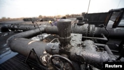 Engineers check oil pipelines in a largely damaged oilfield, Heglig, South Kordofan state, Sudan, April 23, 2012.