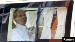 FILE - Thailand's King Bhumibol Adulyadej sits in a vehicle as he leaves Siriraj Hospital for the Grand Palace to join a ceremony marking Coronation Day in Bangkok, May 5, 2015.