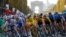 Slovenia's Tadej Pogacar, wearing the overall leader's yellow jersey, center, rides down Champs Elysees with the pack during the Tour de France on Sept. 20, 2020.