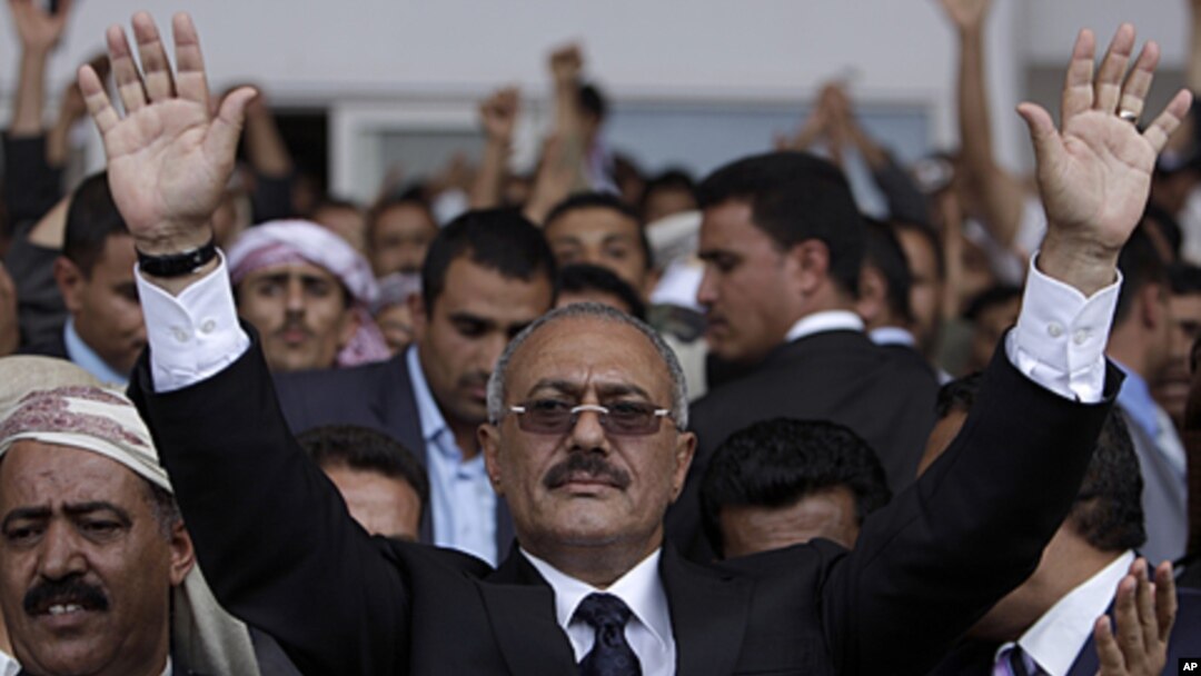 Yemeni President Ali Abdullah Saleh waves to his supporters, not pictured, during a rally in Sana'a, April 15, 2011