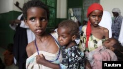 Somali girls carry their malnourished siblings in Banadir hospital, south of capital Mogadishu, August 28, 2011.