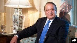 Pakistan Prime Minister Nawaz Sharif looks towards photographers as he meets with Secretary of State John Kerry at the State Department in Washington, Oct. 20, 2013. 