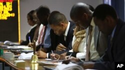 Traders work at the Zimbabwe Stock Exchange in Harare, Aug. 6, 2013. The country's stock exchange lost more than $650 million in value after plunging 11 percent on its first trade following the announcement of the country's election results.