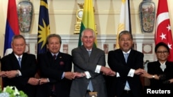 U.S. Secretary of State Rex Tillerson, center, poses with ASEAN foreign ministers before a working lunch at the State Department in Washington, U.S., May 4, 2017. 