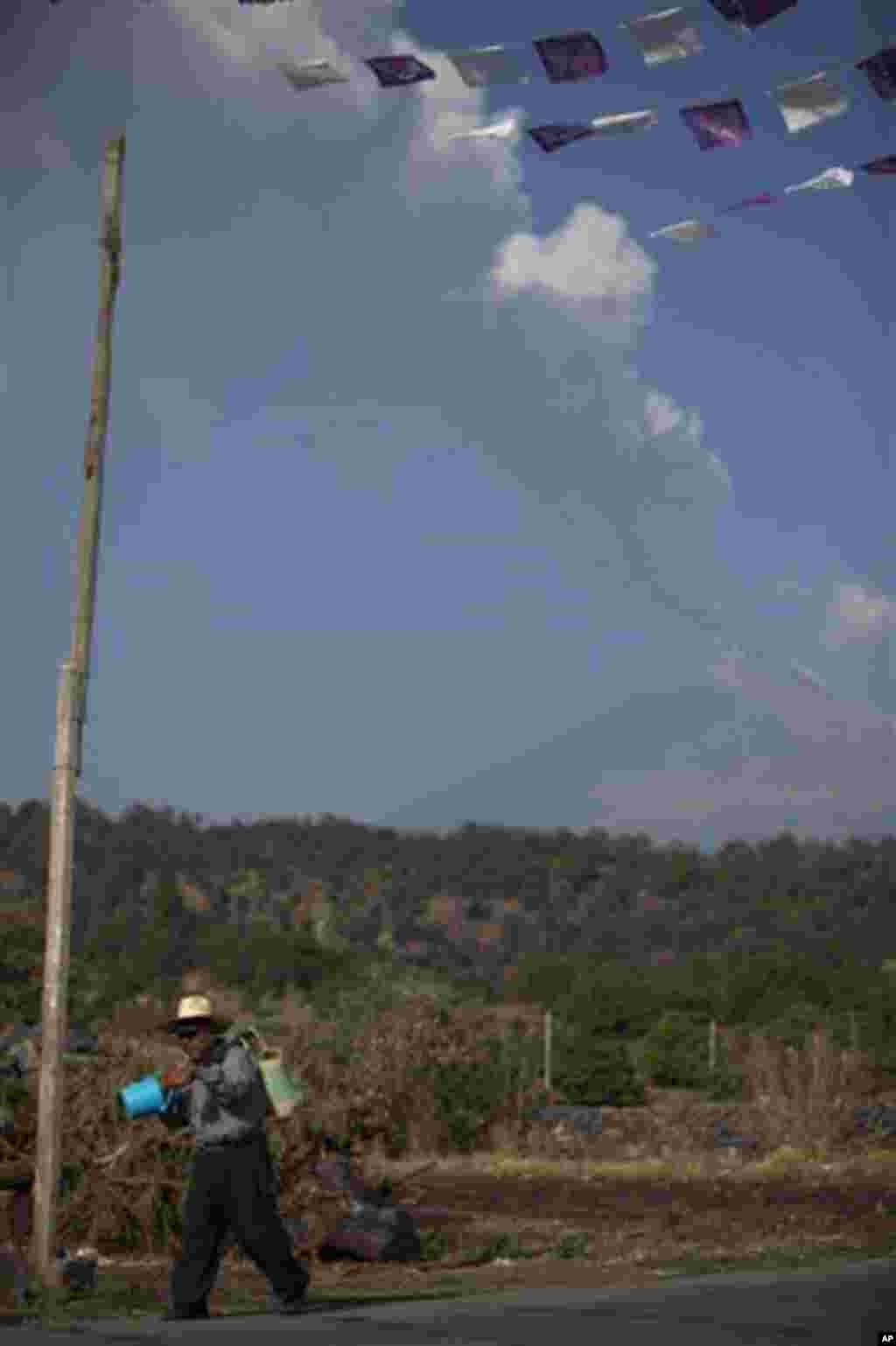 A plume of ash and steam rises from Popocatepetl volcano as seen from San Nicolas, Mexico, Friday, April 20, 2012. Mexico's Popocatepetl volcano is continuing to spout gases and hot rock fragments and it is dusting towns on its flanks with volcanic ash. (