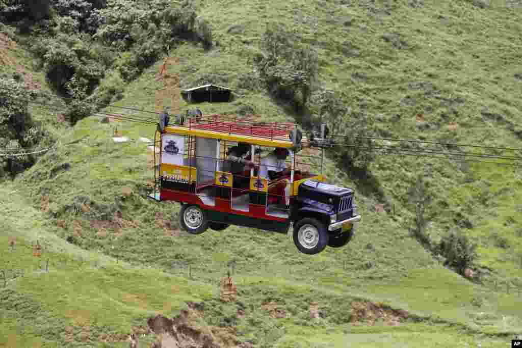 Tourists ride a cable car in Pitalito, Colombia, April 5, 2017.