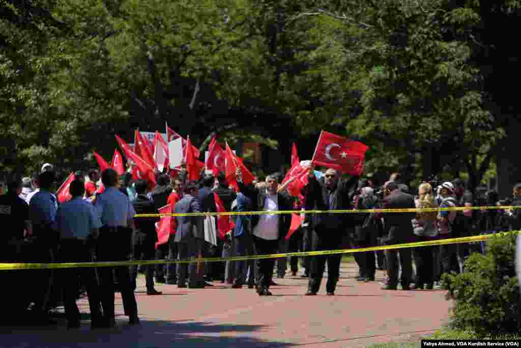 Supporters of Turkish President Recep Tayyip Erdogan react to anti-Erdogan supporters on the other side of a line of police officers outside the White House in Washington, D.C., May 16, 2017.