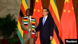 FILE - Zimbabwean President Emmerson Mnangagwa shakes hands with Chinese Premier Li Keqiang before their meeting at the Great Hall of the People in Beijing, China, April 4, 2018. 