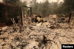 The debris of a burned home is seen after the Carr Fire west of Redding, Calif, July 28, 2018.
