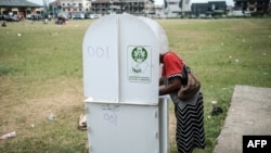 FILE: A woman prepares her ballot to cast as voting in the presidential and parliamentary elections on February 23, 2019, at a polling station in Port Harcourt, southern Nigeria. - 