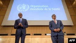 Rwandan President Paul Kagame (L) and World Health Organization (WHO) Director-General Tedros Adhanom Ghebreyesus attends the opening day of the World Health Assembly, an annual meeting with health representatives to discuss a range of global health issues, on May 21, 2018 in Geneva. 