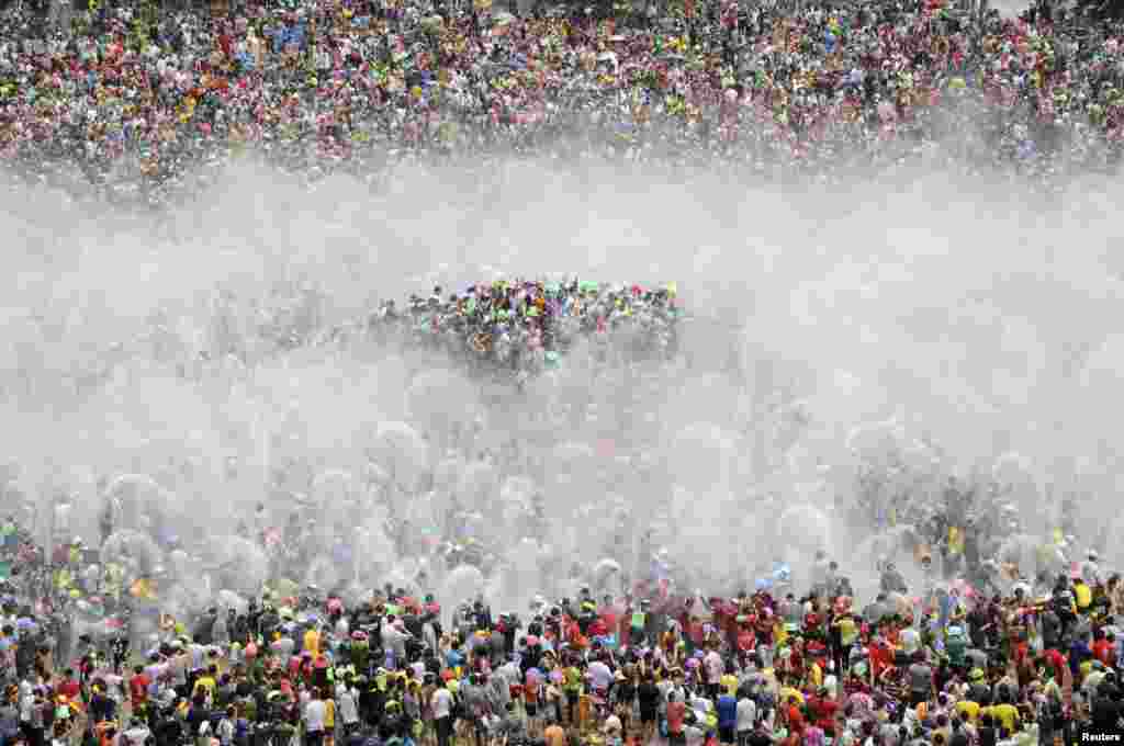 Visitors participate in the annual water-splashing festival to mark the New Year of the Dai minority in Xishuang Banna, Yunnan province.