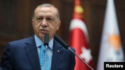 Turkish President Tayyip Erdogan addresses parliamentarians from his ruling AK Party during a meeting at the parliament in Ankara, Turkey, July 24, 2018.