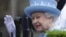 Britain's Queen Elizabeth waves as she arrives for a service of thanksgiving at Saint Macartin's Cathedral in Enniskillen, Northern Ireland, June 26, 2012. 