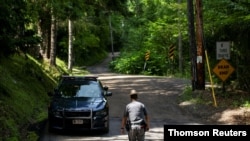 A New York State Trooper stands guard outside the home where attorney Roy Den Hollander was found dead after allegedly killing the son of federal judge Esther Salas and wounding her husband, in Catskills, New York, July 20, 2020.