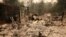 The debris of a burned home is seen after the Carr Fire west of Redding, Calif, July 28, 2018. 