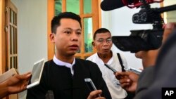 FILE - Arnt Khaung Min, deputy chief editor of the weekly Myanmar Herald, speaks to journalists as he leaves a township court in Naypyitaw, Myanmar, July 21, 2015. He and the paper's chief editor Kyaw Swa Win were fined for violating the media law by printing articles affecting an individual's reputation.