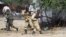 Somali government soldiers open fire during an ambush by al-Shabaab rebels on the outskirts of Elasha town, May 29, 2012.