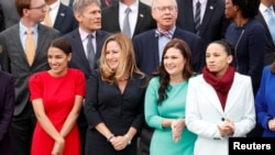 Female Democratic Representatives-elect, from left, Alexandria Ocasio-Cortez of New York, Debbie Mucarsel-Powell of Florida, Abby Finkenauer of Iowa and Sharice Davids of Kansas pose in the front row during a class picture with incoming newly elected memb