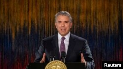 FILE - Colombia's President Ivan Duque addresses the nation in a televised speech, in Bogota, Colombia, Nov. 22, 2019. 