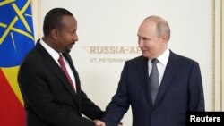 FILE - Russian President Vladimir Putin shakes hands with Ethiopian Prime Minister Abiy Ahmed during a meeting on the sidelines of Russia-Africa summit in Saint Petersburg, Russia, July 26, 2023.