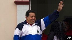 Venezuela's President Hugo Chavez waves to supporters from Miraflores presidential palace at an event marking the 10th anniversary of his return to power after a failed coup in Caracas, Venezuela, April 13, 2012 (file photo).