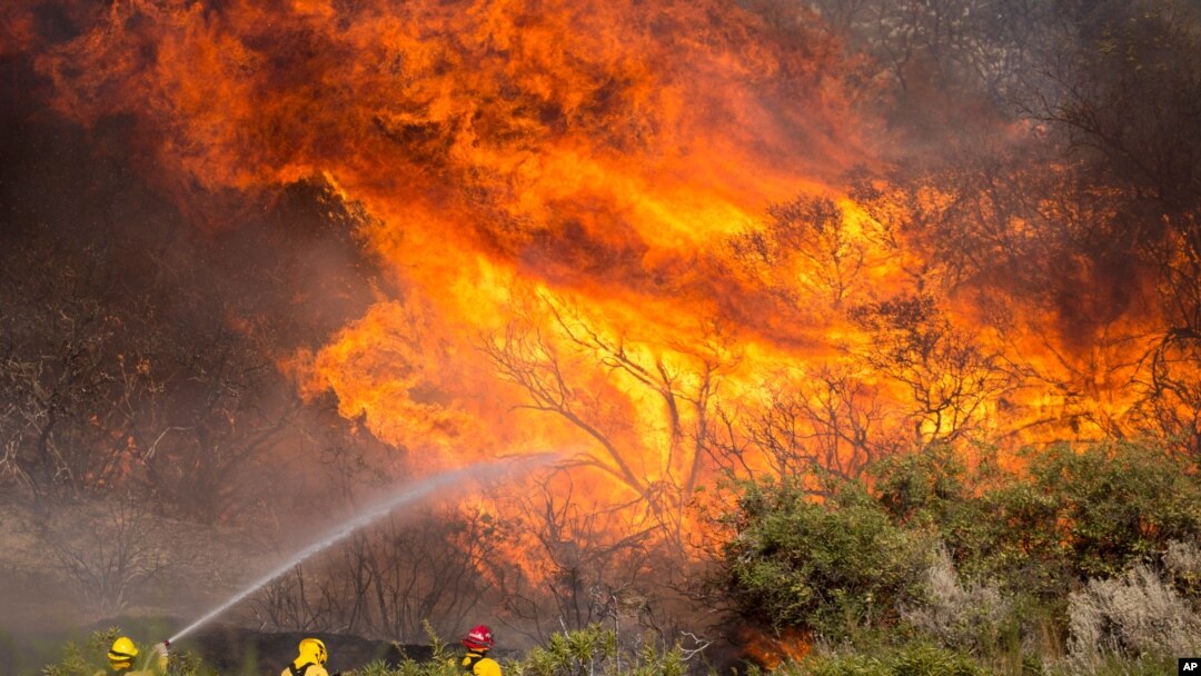Firefighters battle the Apple Fire in Banning, California, August 2, 2020.
