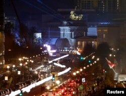 The installation 'Lichtgrenze' (Border of Light) along a former Berlin Wall location is illuminated next to the Brandenburg Gate in Berlin November 7, 2014. A part of the inner city of Berlin is being temporarily divided from November 7 to 9, with a light