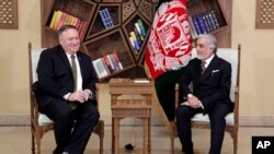 FILE - U.S. Secretary of State Mike Pompeo, left, meets with Abdullah Abdullah the main political rival of President Ashraf Ghani at the Sepidar Palace, in Kabul, Afghanistan, March 23, 2020.