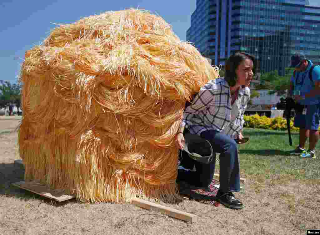 Roxana Casillas, one of the artists behind the Trump Hut, a luxury camping hut modelled on the hairstyle of Republican presidential candidate Donald Trump, exits the den near the Republican National Convention in Cleveland, Ohio, July 19, 2016.