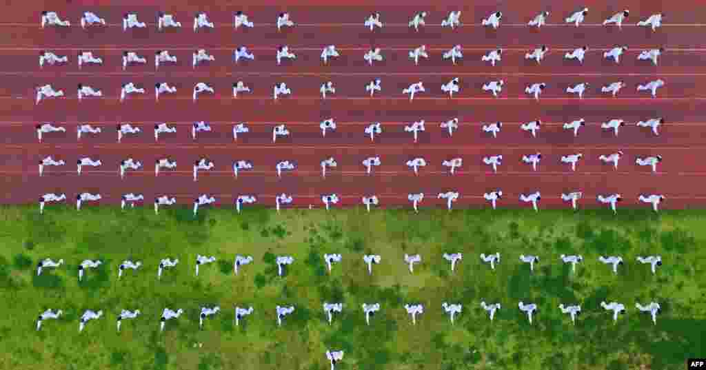 People perform Tai Chi as part of a National Fitness Day event in Rongan in China&#39;s southwestern Guizhou province.