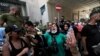 Former employees of the American University Medical Center react during a demonstration outside the hospital in the capital Beirut, on July 20, 2020, after they were dismissed from their jobs last week.