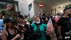 Former employees of the American University Medical Center react during a demonstration outside the hospital in the capital Beirut, on July 20, 2020, after they were dismissed from their jobs last week.