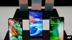 The new Samsung S10 phones are displayed Feb. 20, 2019, in San Francisco. Samsung is hailing the 10th anniversary of its first smartphone with three new models that it hopes reverses a sales slump in an industry recycling the same ideas.