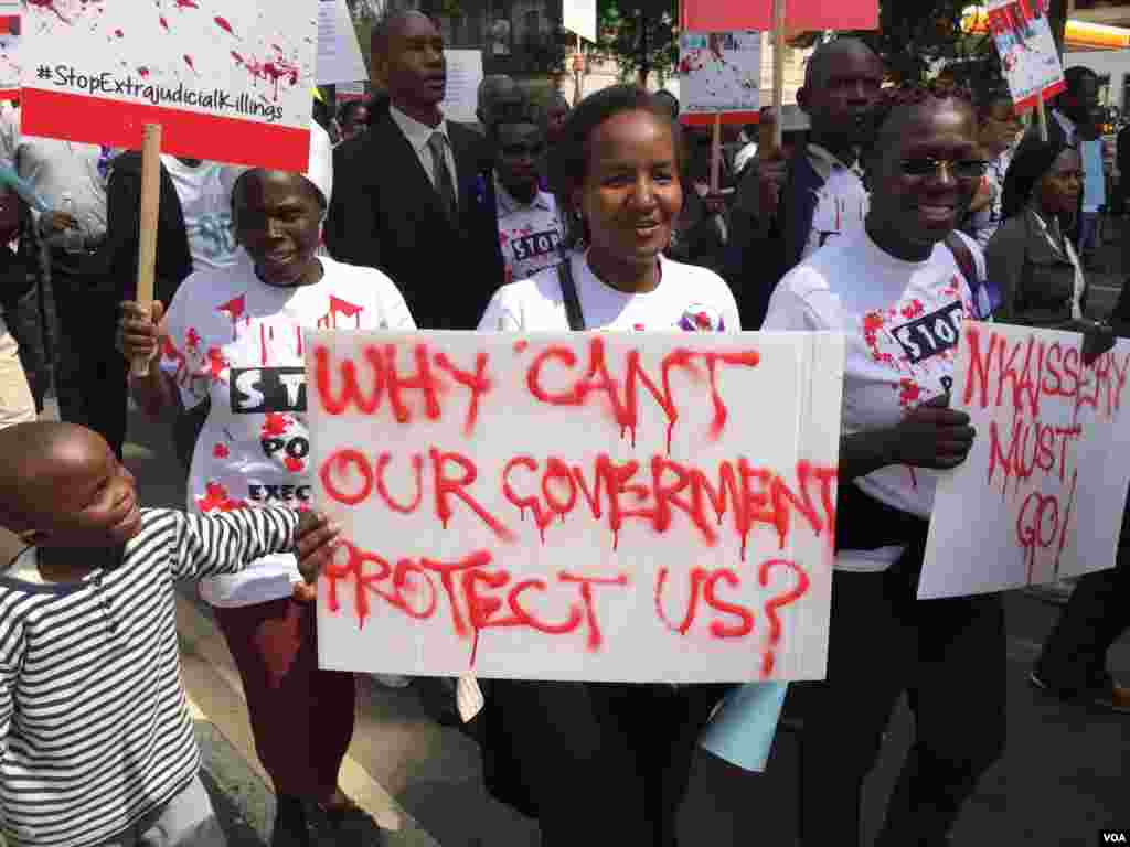 Protester Jaciata Okumu carries a sign during a march against policy impunity in Nairobi, Kenya, July 4, 2016. (J. Craig/VOA) 