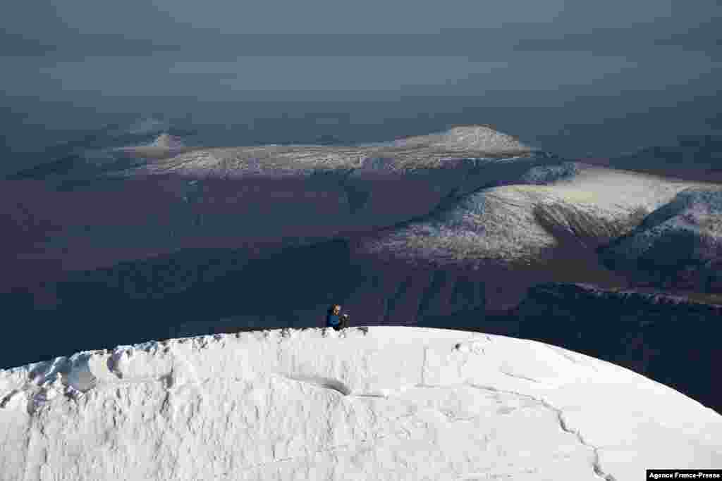 Researcher Ninis Rosqvist takes GPS measurements of the mountain’s height at the peak of the southern summit of Kebnekaise in northern Sweden. The southern summit, which was the tallest, has shrunk because ice at its top is melting.