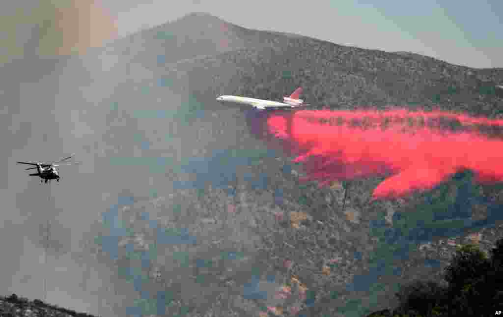 An air tanker drops fire retardant at a containment line northeast of Lower Lake, Calif.