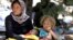 A displaced family from the minority Yazidi sect, fleeing the violence in the Iraqi town of Sinjar, waits for food while resting at the Iraqi-Syrian border crossing in Fishkhabour, Dohuk province August 13, 2014.