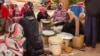 (FILE) Sudanese women from community kitchens run by local volunteers prepare meals for people who are affected by conflict and extreme hunger and are out of reach of international aid efforts, in Omdurman, Sudan, May 13, 2024. 