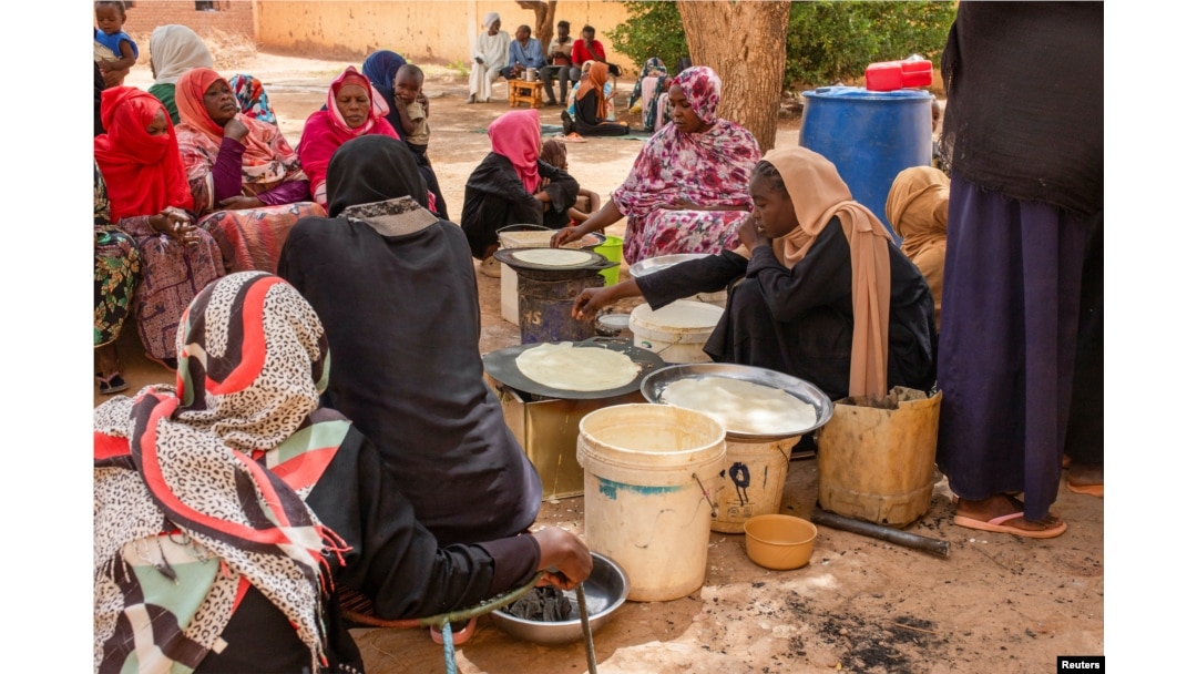 FILE - Sudanese women from community kitchens run by local volunteers prepare meals for people who are affected by conflict and extreme hunger and are out of reach of international aid efforts, in Omdurman, Sudan, May 13, 2024.