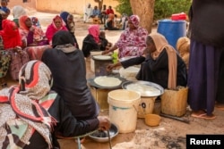 FILE - Sudanese women from community kitchens run by local volunteers prepare meals for people who are affected by conflict and extreme hunger and are out of reach of international aid efforts, in Omdurman, Sudan, May 13, 2024.