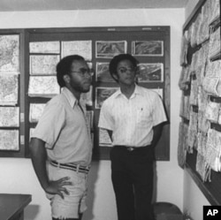 Warren Washington and a fellow student looking at weather maps in 1977.