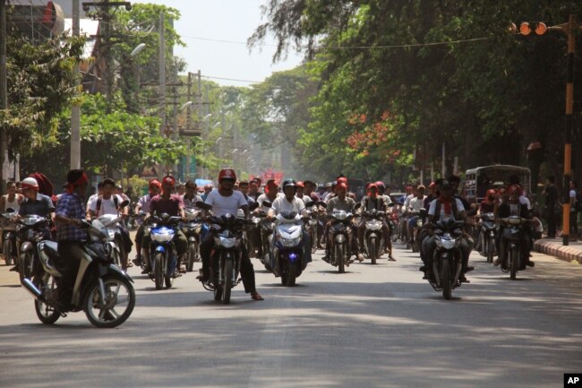 Hard-line Buddhists ride on motorbikes during a protest march, led by Rakhine State's dominant Arakan National Party, against the government's plan to give citizenship to some members of the persecuted Rohingya Muslim minority community in Sittwe, Rakhine State.