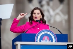 FILE - Michigan Gov. Gretchen Whitmer addresses the crowd during inauguration ceremonies, Sunday, Jan. 1, 2023, outside the state Capitol in Lansing, Mich. (AP Photo/Al Goldis)