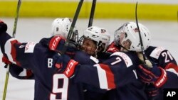 United States forward Brianna Decker is surrounded by teammates after scoring during the second period of a IIHF Women's World Championship hockey tournament game against Canada, March 31, 2017, in Plymouth, Mich.